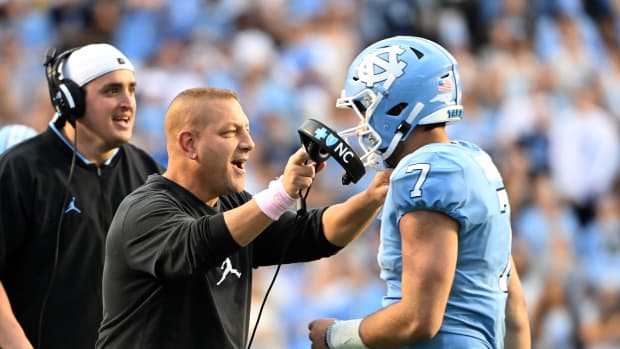 North Carolina offensive coordinator Phil Longo celebrates a big play with Tar Heel quarterback Sam Howell.